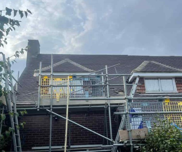 This is a photo of a roof with two dormers that is having some damaged tiles replaced. Works carried out by SCG Roofing Earls Barton