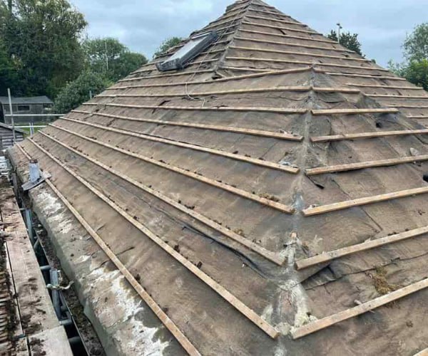 This is a photo of a hip roof that has been stripped back to the battens, and is awaiting a new roof covering to be installed. Works carried out by SCG Roofing Earls Barton